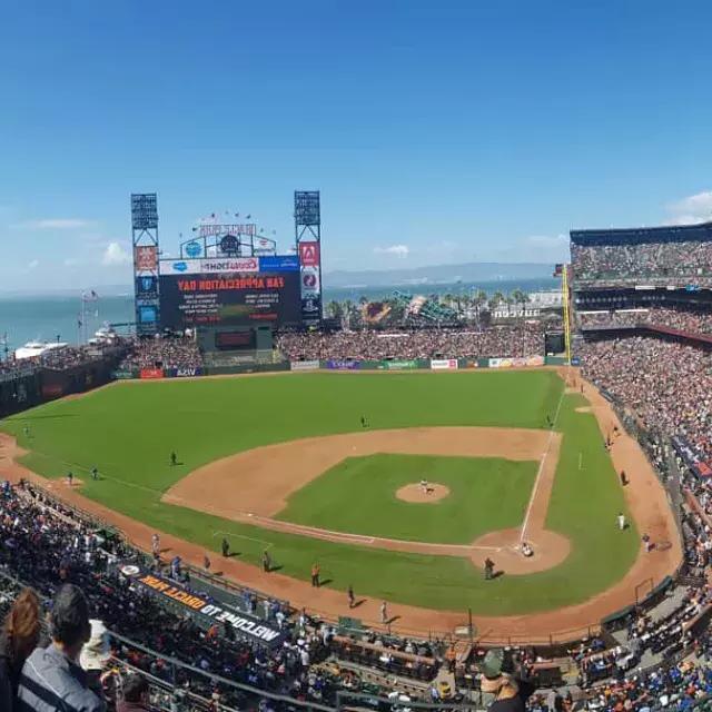 A view of San Francisco's 甲骨文公园 looking out from the stands, with the baseball diamond in the foreground and San Francisco Bay in the background.